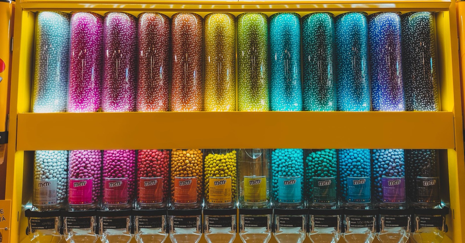 Colourful candy dispensers filled with pick and mix sweets in a shop